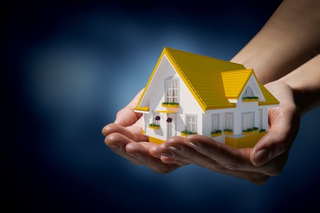 Human hands holding model of dream house-1